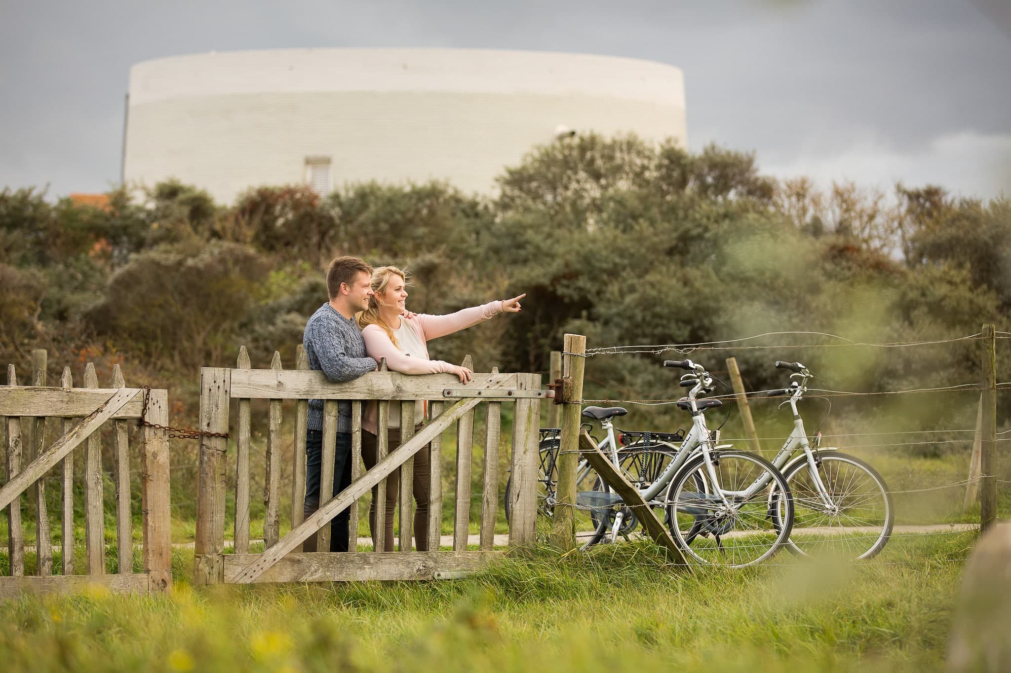 Young couple pointing at the dunes.