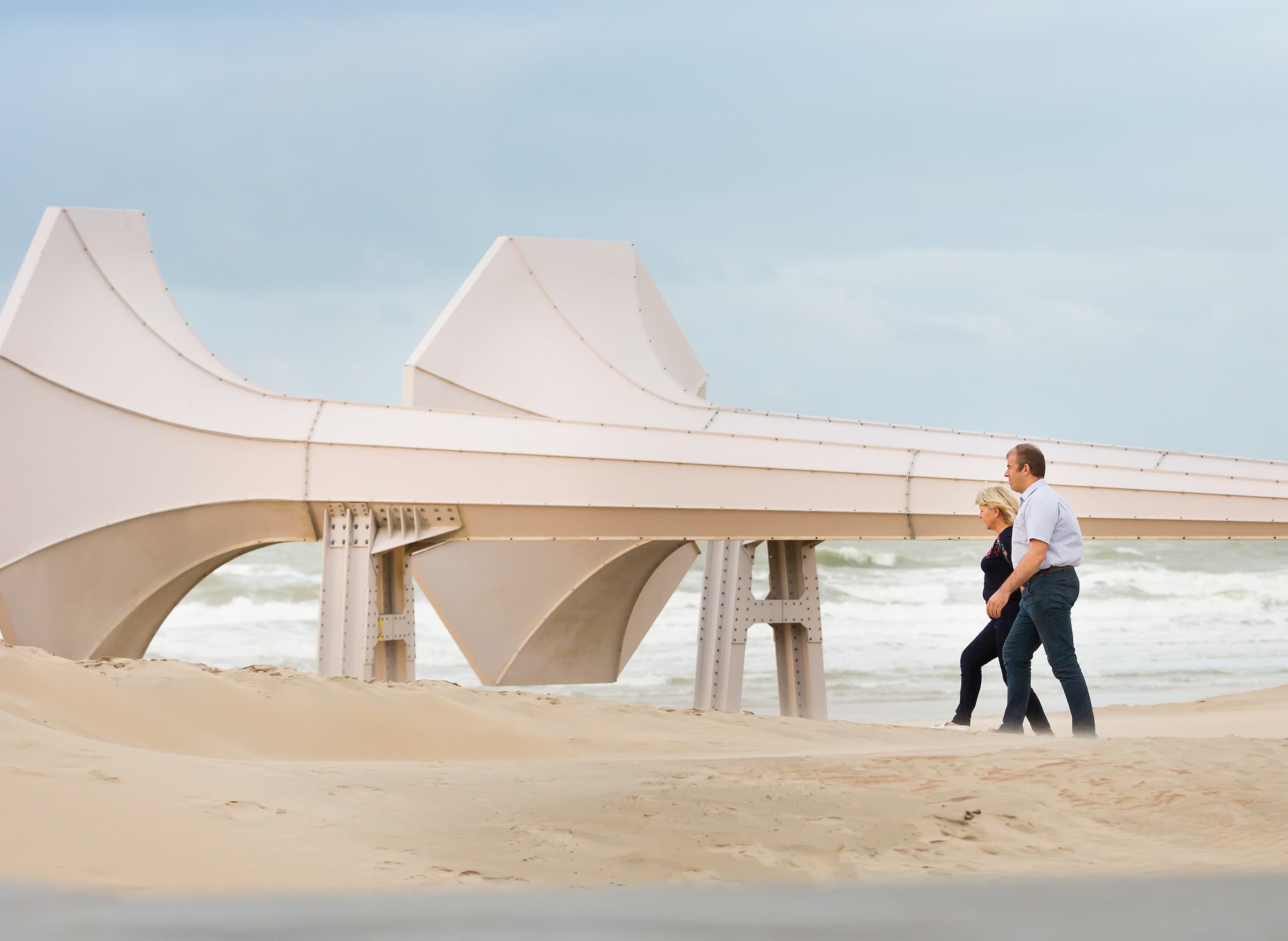 Older couple walking on the beach